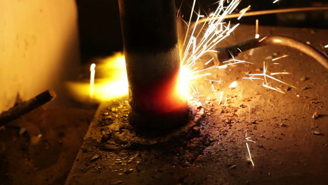 Close up process of welding metals in darkness