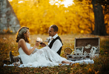 Beautiful wedding couple at a picnic under tree