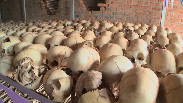 Slow pan across hundreds of skulls in a display in a church.