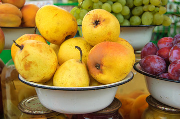 Naklejka na ściany i meble Yellow pears in an old white bowl.