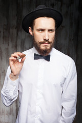 Cheerful young man with beard and cigar