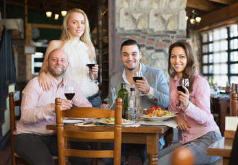 Adults having dinner in restaurant