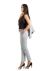 Confident young business woman in formal suit holding jacket over the shoulder