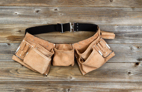 Leather tool belt on rustic wooden boards