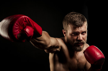 Athletic bearded boxer with gloves on a dark background - 91733826