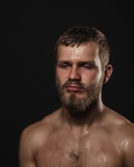 Fototapeta premium Athletic bearded boxer on a dark background