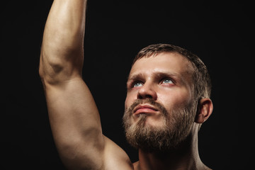 Athletic bearded boxer with gloves on a dark background - 91733897