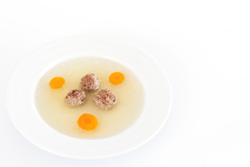Plate of soup with carrot and meat balls