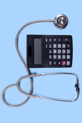 Closeup of stethoscope with calculator