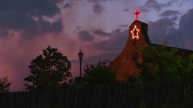 An adobe church at dusk.
