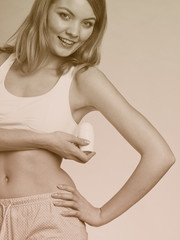 Fototapeta premium Girl applying stick deodorant in armpit.