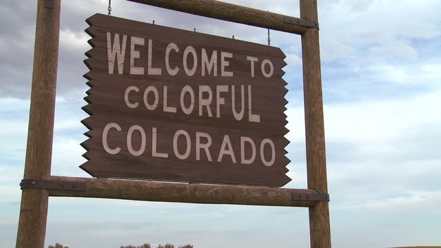 A roadside sign welcomes visitors to Colorado.