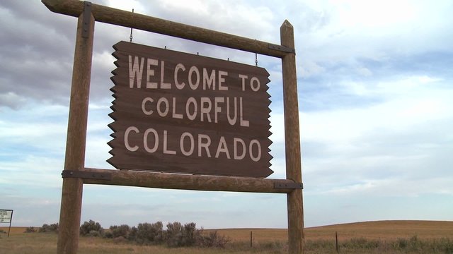 A roadside sign welcomes visitors to Colorado.