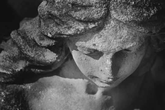 Vintage image of a sad angel on a cemetery (fragment)