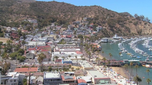 High angle panning wide overview of the town of Avalon on catalina Island with the opera house in background.