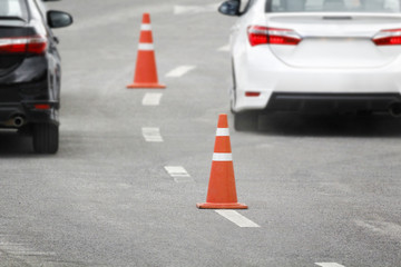 traffic cone in rush hour , focus at cone