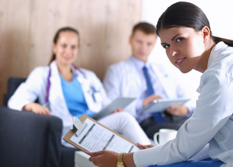 Fototapeta premium A group of doctors dscussing patient details.