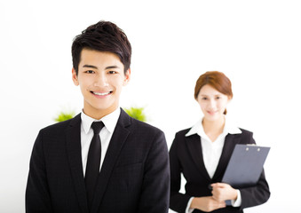 happy business man and woman standing  in office