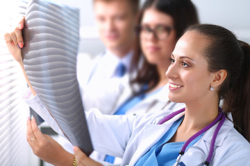 Doctors inspecting a patient's x-ray.