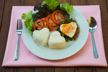 Rice topped with stir-fried pork and basil with egg, Thai style