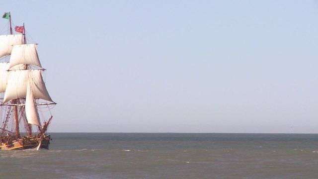 A tall master schooner sails on the high seas.