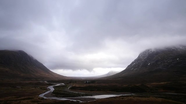 timelapse of fast moving clouds over rannoch moor and river during winter in scotland