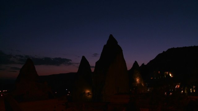 Strange spires are silhouetted at dusk at Cappadocia, Turkey.