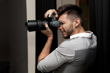 Young man with professional camera