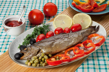 Trout baked in the oven on a country table
