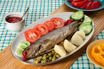 Trout baked in the oven on a country table