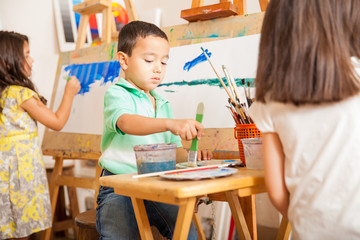 Little kids painting in art class