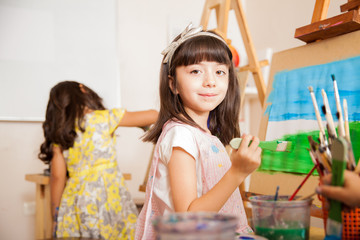 Cute girl working on a painting