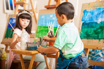 Little kids working on a painting