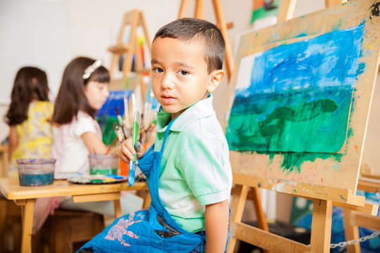 Latin Boy Painting In Art Class