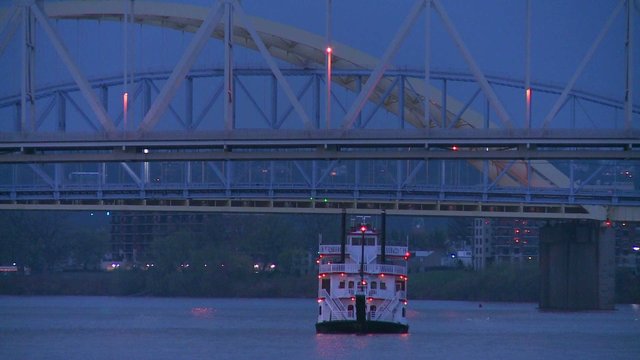 A Riverboat Passes Under The Bridges Of Cincinnati On The Ohio River.