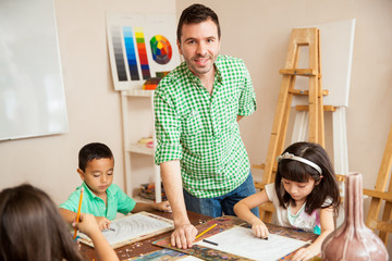 Hispanic art teacher with his students