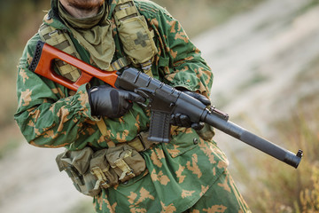 Fototapeta premium russian soldier in the battlefield with a rifle