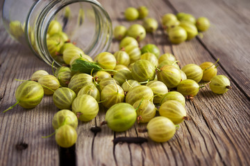 Organic gooseberries on old wooden background. Selective focus