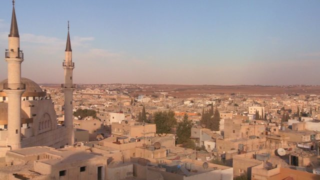 Pan to reveal a mosque towering above the Arab city of Madaba in Jordan.