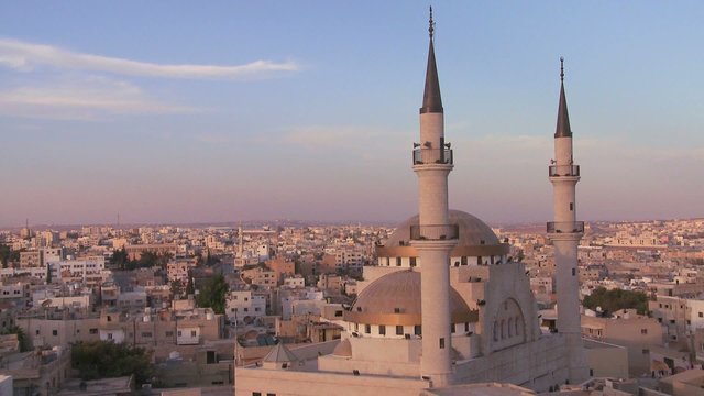 Beautiful generic wide shot of a mosque towering above the Arab city of Madaba in Jordan.