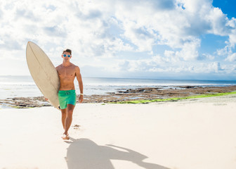 Naklejka na ściany i meble professional surfer holding a surf board
