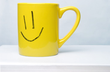 yellow smile cup on white background