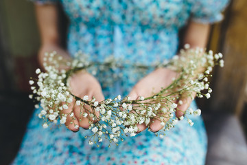 Girl holds head wreath in hands