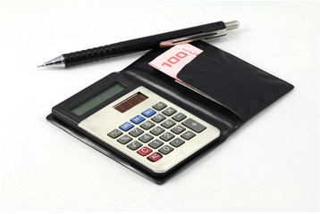 A calculator, a pen and Thai cash on isolated background.