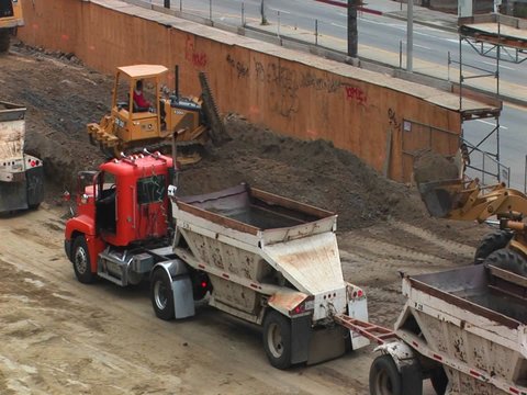 Tractors move dirt at a work site.