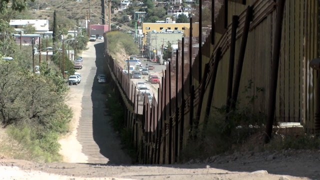 A large fence separates a border community.