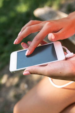 Close up image of female hands using  smart phone.