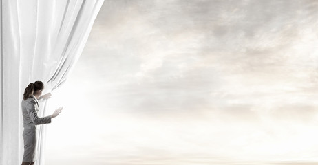 Woman open curtain