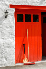 Red door to the still room at Edradour distillery in Perthshire, Scotland. © cornfield