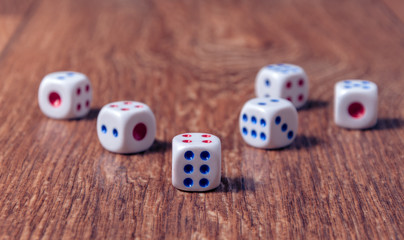 Rolling three dice on a wooden desk